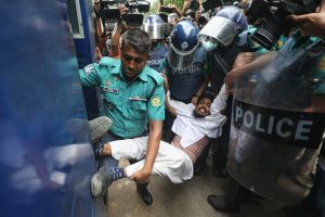 Members of the law and order forces are dragging a protesting student to a prison van in Dhaka University campus. 17 July 2024. [Mo: Hasan/BannerNews]